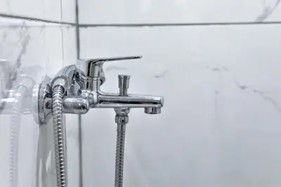 a shower faucet with a hose in a bathroom at Dimosthenis_loft2 in Athens