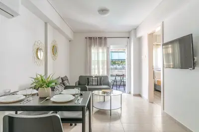 a living room with a table and a couch at Elvita Apartments 4 in Athens