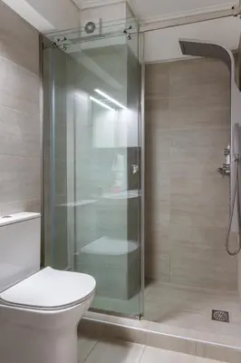 a bathroom with a toilet and a glass shower at Elvita Apartments 4 in Athens