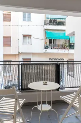 a table and chairs on a balcony with a view of a building at Elvita Apartments 4 in Athens