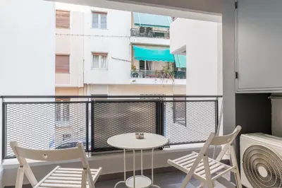 a balcony with a table and chairs and a window at Elvita Apartments 4 in Athens