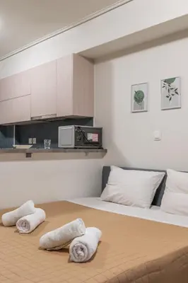 a bedroom with a bed with towels on it at Elvita Apartments 4 in Athens