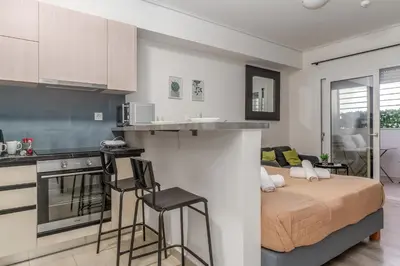 a kitchen and a bedroom with a bed in a room at Elvita Apartments 4 in Athens