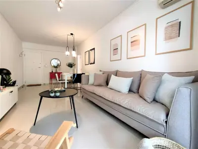 a living room with a couch and a table at Vouliagmeni Iasonos Residence Central Stylish Flat in Athens