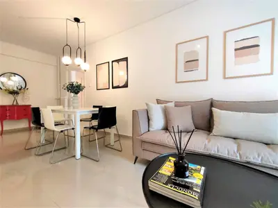 a living room with a couch and a table at Vouliagmeni Iasonos Residence Central Stylish Flat in Athens