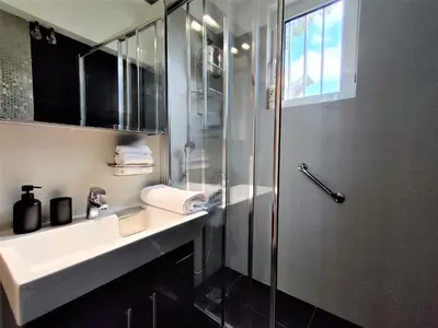 a bathroom with a shower and a sink and a shower at Vouliagmeni Iasonos Residence Central Stylish Flat in Athens