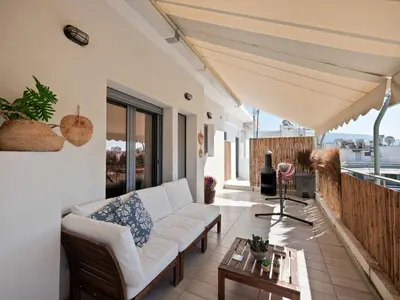 a living room with a couch and a table at Athens luxurious loft in Athens