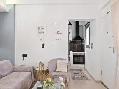 a living room with a couch and a chair at Athens luxurious loft in Athens