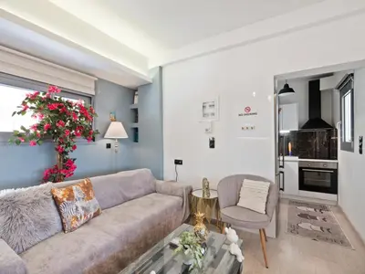 a living room with a couch and a chair at Athens luxurious loft in Athens