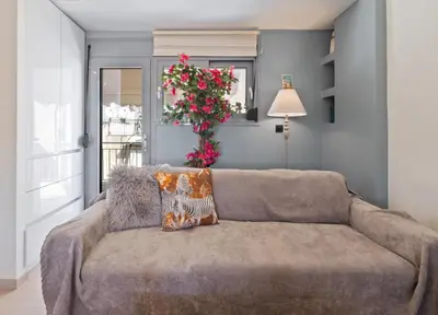 a couch in a living room with a plant at Athens luxurious loft in Athens