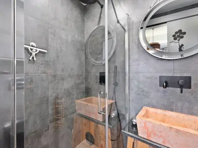 a bathroom with a shower with a sink and a mirror at Athens luxurious loft in Athens