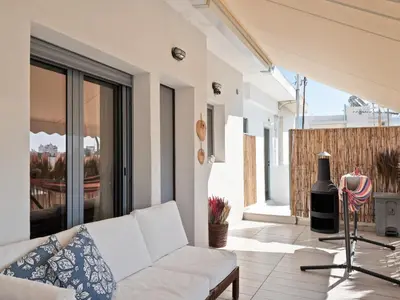 a living room with a white couch on a balcony at Athens luxurious loft in Athens
