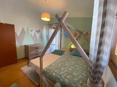 a childs bedroom with a bed with a canopy at Grand Villa Lagonisi in Kalívia Thorikoú