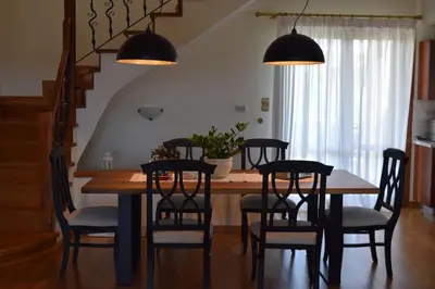 a dining room with a table and chairs at Grand Villa Lagonisi in Kalívia Thorikoú