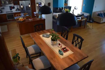 a wooden table and chairs in a living room at Grand Villa Lagonisi in Kalívia Thorikoú
