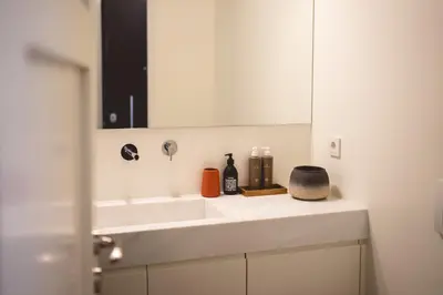 a bathroom with a white sink and a mirror at Bugan-Villa in Athens