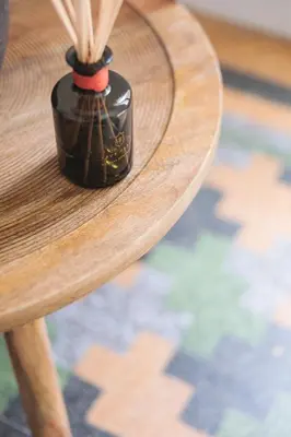 a black vase sitting on top of a wooden table at Bugan-Villa in Athens