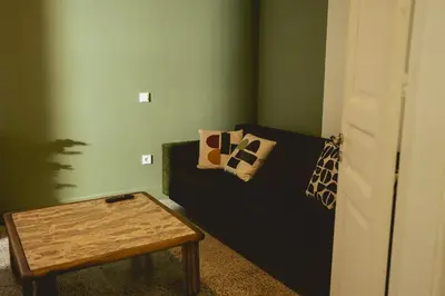 a living room with a couch and a coffee table at Bugan-Villa in Athens