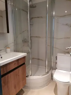 a bathroom with a shower and a toilet and a sink at Syntagma Nest Apartment in Athens