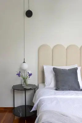 a bedroom with a bed and a table with flowers on it at Acropolis Villa 3BR 9ppl 10 minutes Metro&Museum in Athens