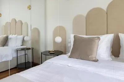 a bedroom with a large bed with white sheets and pillows at Acropolis Villa 3BR 9ppl 10 minutes Metro&Museum in Athens