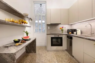 a kitchen with white cabinets and a counter top at Acropolis Villa 3BR 9ppl 10 minutes Metro&Museum in Athens