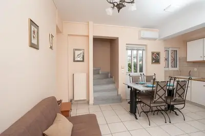 a living room with a couch and a table at Villa Clotho in Porto Rafti