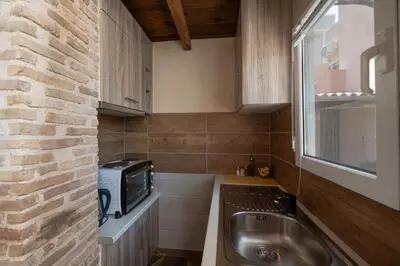 a small kitchen with a sink and a microwave at Villa Clotho in Porto Rafti