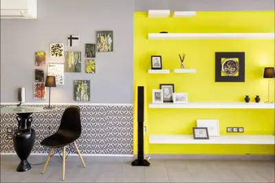 a yellow wall with a table and a chair in a room at Stylish Boutique Loft With Private Balcony in Athens