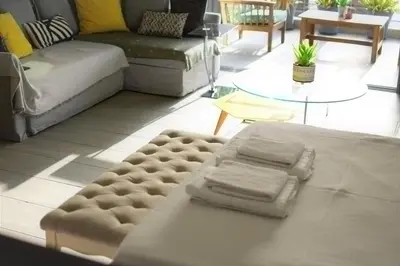 a living room with a couch and a table at Stylish Boutique Loft With Private Balcony in Athens
