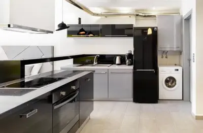 a kitchen with a black refrigerator and a dishwasher at Stylish Boutique Loft With Private Balcony in Athens