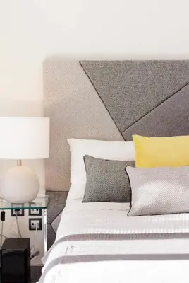 a bed with yellow and gray pillows and a lamp at Stylish Boutique Loft With Private Balcony in Athens