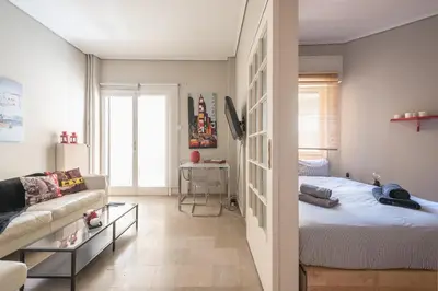 a living room with a bed and a couch at Glyfada Central Walk to Shops, Near Beach in Athens