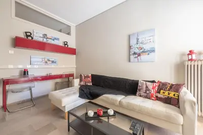a living room with a couch and a table at Glyfada Central Walk to Shops, Near Beach in Athens