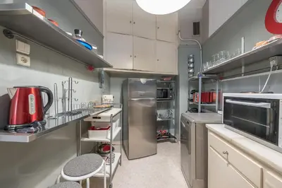 a kitchen with a stainless steel refrigerator and cabinets at Glyfada Central Walk to Shops, Near Beach in Athens