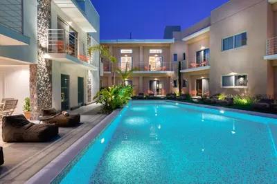 a swimming pool in the middle of a house at Saronis Suites in Saronida