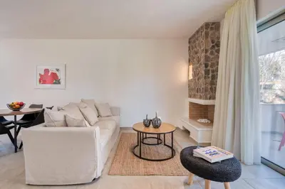 a living room with a white couch and a table at Saronis Suites in Saronida