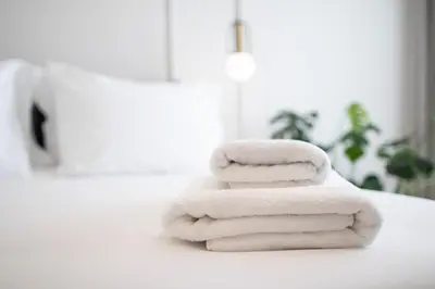 two towels stacked on a counter in a bathroom at Mythodea Athens Suites in Athens