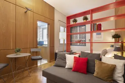 a living room with a couch with colorful pillows at Vibrant apartment in Kolonaki area in Athens