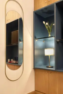a mirror and a lamp in a room at Vibrant apartment in Kolonaki area in Athens