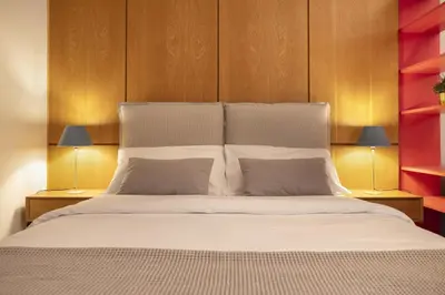 a bedroom with a large white bed with two lamps at Vibrant apartment in Kolonaki area in Athens