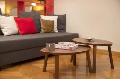a living room with a couch and two tables at Vibrant apartment in Kolonaki area in Athens