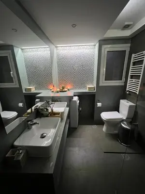 a bathroom with two sinks and a toilet at Live Minimal in Athens