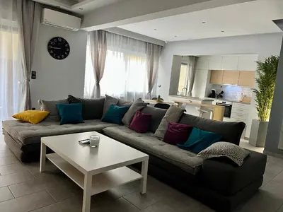 a living room with a couch and a table at Live Minimal in Athens