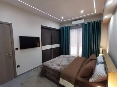 a bedroom with a bed and a flat screen tv at Live Minimal in Athens