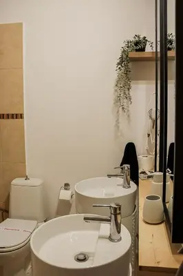 a bathroom with two sinks and a toilet at Cleo in Spáta