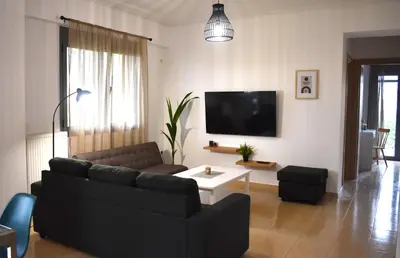 a living room with a couch and a tv at Cleo in Spáta