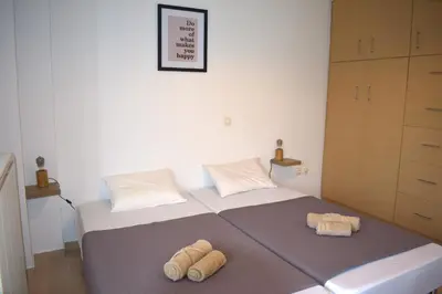 a bedroom with a bed with two towels on it at Cleo in Spáta