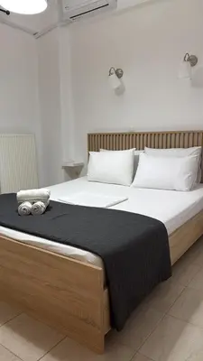 a bedroom with a large bed with two pillows at Cleo in Spáta