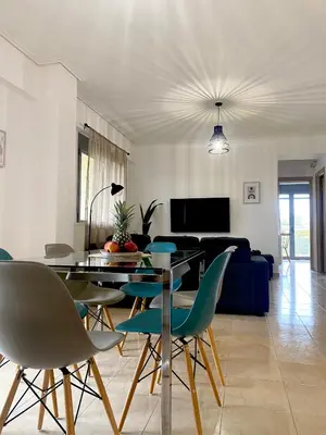 a living room with a dining table and chairs at Cleo in Spáta